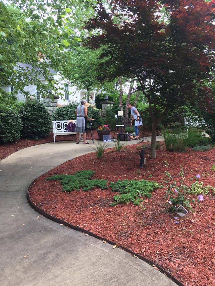 Sterling Meadows resident painters under the brick portico